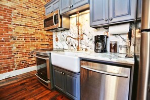 Fully equipped, newly remodelled, kitchen with marble, stainless, custom fixtures, dishwasher, fridge, freezer, induction stove, and all the equipment to make a gourmet meal.