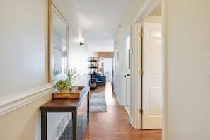 Hallway leading to the bedroom, bathroom, open living room/kitchen, and balcony directly across from the Battleship.