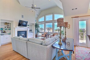 In the central living area, turn on the gas fireplace and enjoy movie night on the comfy couch or simply relax and bask in the sunshine as it filters in through several large windows.