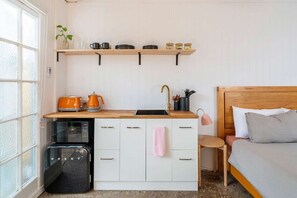The kitchenette with sink, kettle, toaster, microwave etc.