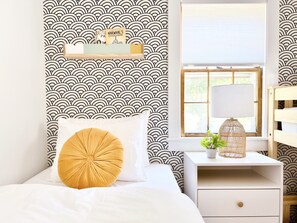 3 twin beds in the bunkroom appropriately decorated for families