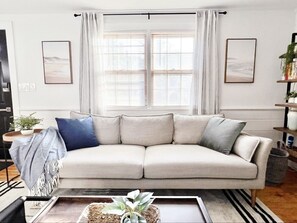 Enjoy a book on the comfy sofa while the afternoon sun fills the space.