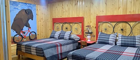 comfy queen size beds in the Tour de Bison Cabin at The Lazy Buffalo