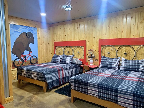 comfy queen size beds in the Tour de Bison Cabin at The Lazy Buffalo