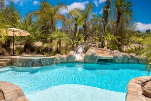 Luxurious pool surrounded by foilage for a sense of privacy.