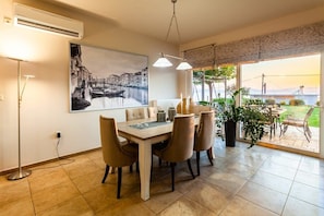 Enjoy meals in a spacious dining space with direct access to the garden