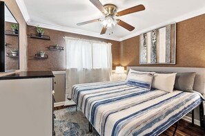 Master Bedroom with a comfortable King SIze Bed, two end tables with lamps to set the ambiance, ceiling fan if you prefer however the AC is very efficient.  Dresser and mirror along with art and deco, not to forget a large closet with hangers and ext