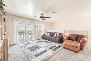 Charming living space with cozy furniture and private balcony