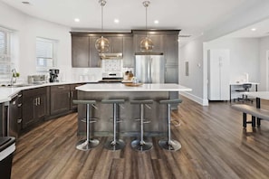 Designer kitchen with island in open concept living area