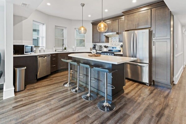 Designer kitchen with island in open concept living area