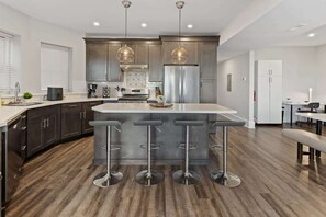 Designer kitchen with island in open concept living area