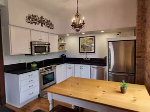 Fully equipped kitchen with antique lighting and modern appliances