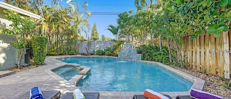 Huge private pool in a lush backyard filled with trees for a zen like vacation