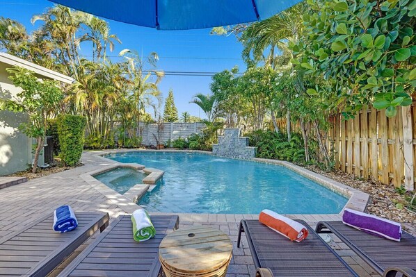 Huge private pool in a lush backyard filled with trees for a zen like vacation