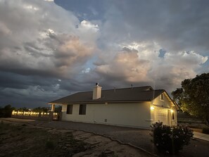 Night view of the side of the house and property 