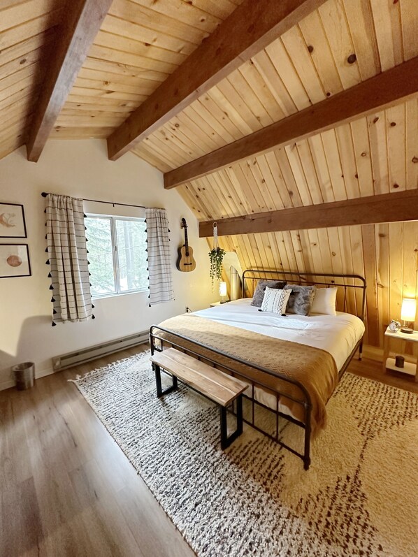 Main Bedroom featuring a king bed, desk, reading nook, and smart TV