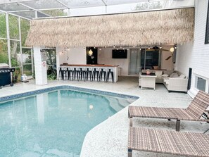 Enjoy our heated pool with ample space for relaxation, complemented by an outdoor couch and a bar with seating for ten. Additionally, unwind on the two lounge chairs, perfect for soaking up the sun or enjoying a refreshing drink.