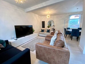 Open modern living/dining room with plenty of seating. 