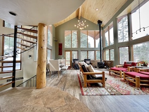 The living room with gorgeous open floor plan surrounded by views of mountains