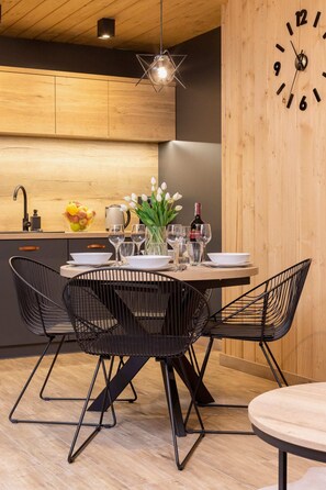 An intimate dining setup with a table for four, wooden accents, and a well-lit ambiance.
