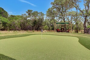 The property features a golf green with tee boxes at 25,50,75, and 100 yards.