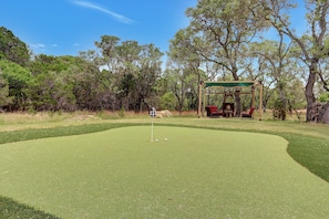 The property features a golf green with tee boxes at 25,50,75, and 100 yards.