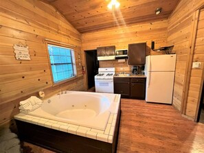 Enjoy the warm water from a jetted hot tub with a kitchenette in the corner