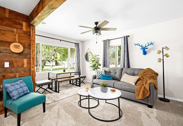 Living room with one of a kind wood accent wall made from 100+ year old timber!