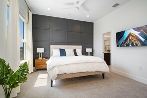 Master bedroom with dedicated work space, smart tv, and blackout shades.