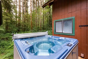 Sparkling hot tub with a forest view