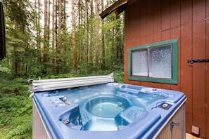 Sparkling hot tub with a forest view