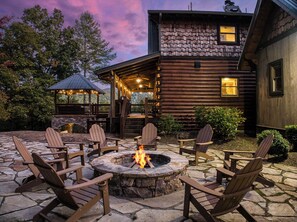 Cozy up around the rustic firepit with seating for 8, firewood & mountain vibes!