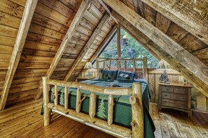 Upstairs loft with King bed and timber frame.