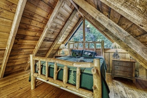Upstairs loft with King bed and timber frame.