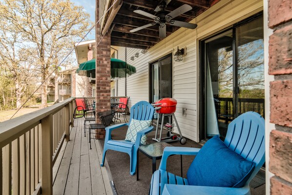 Dining and separate seating area on deck, along with a grill