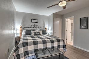 King bed, ceiling fan, ensuite bathroom in master bedroom.