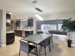 Open casual/formal dining area features wood table and smooth Italian seating.