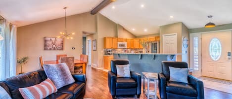 Open living room to kitchen, and dining. 75" Smart TV.