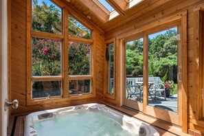 Indoor hot tub accessible from the house and deck