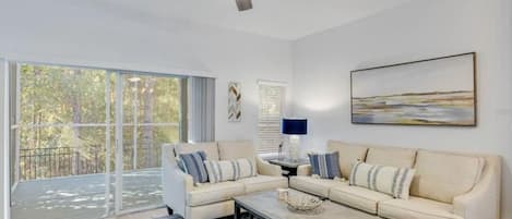 Living room looking out to private screened porch