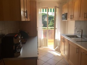 Modern fully furnished kitchen with direct balcony access