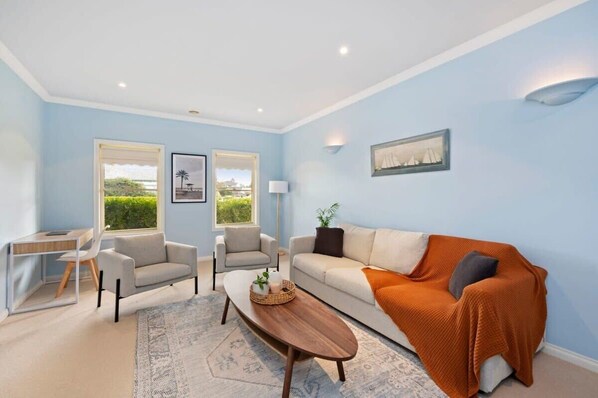 The sunny front lounge offers extra living space and a desk for executives