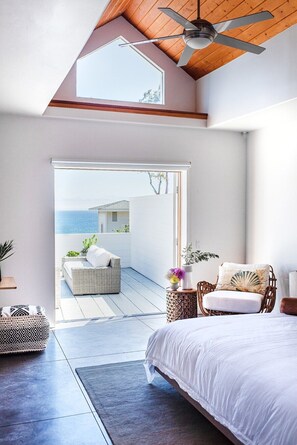 Master Bedroom with french doors opening to the outside seating area with ocean views