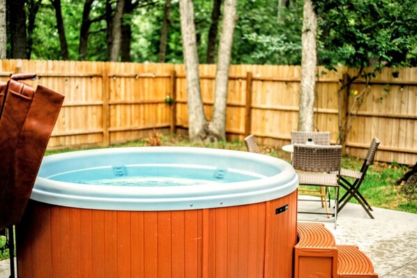 Professionally maintained private hot tub overlooking the backyard.