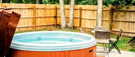 Professionally maintained private hot tub overlooking the backyard.