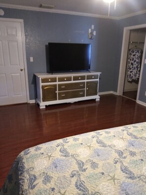 Tons of dresser space with a 55" Roku TV in the Master Bedroom.