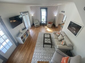 View of living room from stairwell leading up to bedroom 2 and 3 and bathroom 2.