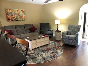 Living room with couch that folds flat into a soft bed.