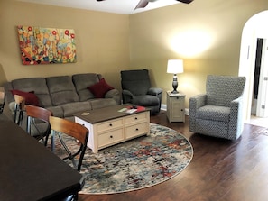 Living room with couch that folds flat into a soft bed.