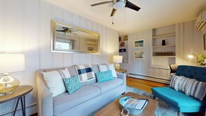 couch, a ceiling fan, coffee table